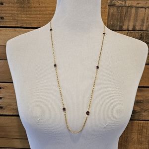 Goldtone Figaro chain with faceted faux amethyst details